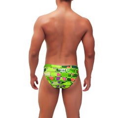 Vibrant lime green icker sea bricks bikini swimwear trunks with bold geometric pink purple and teal accents