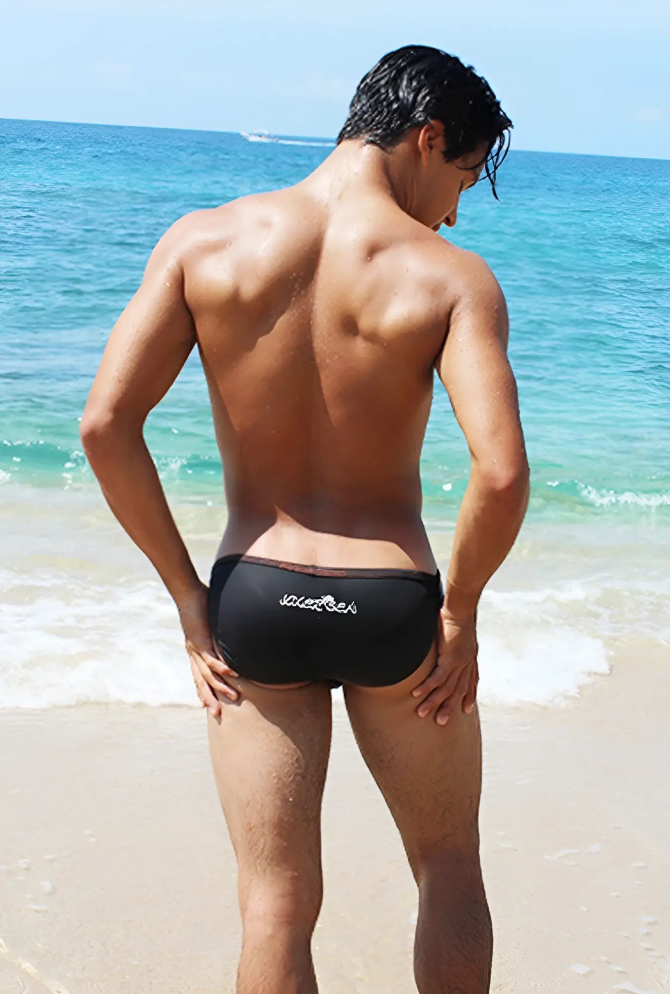 Black icker sea micro slip tanga bikini swimwear showing back with subtle white logo and contrast stitching