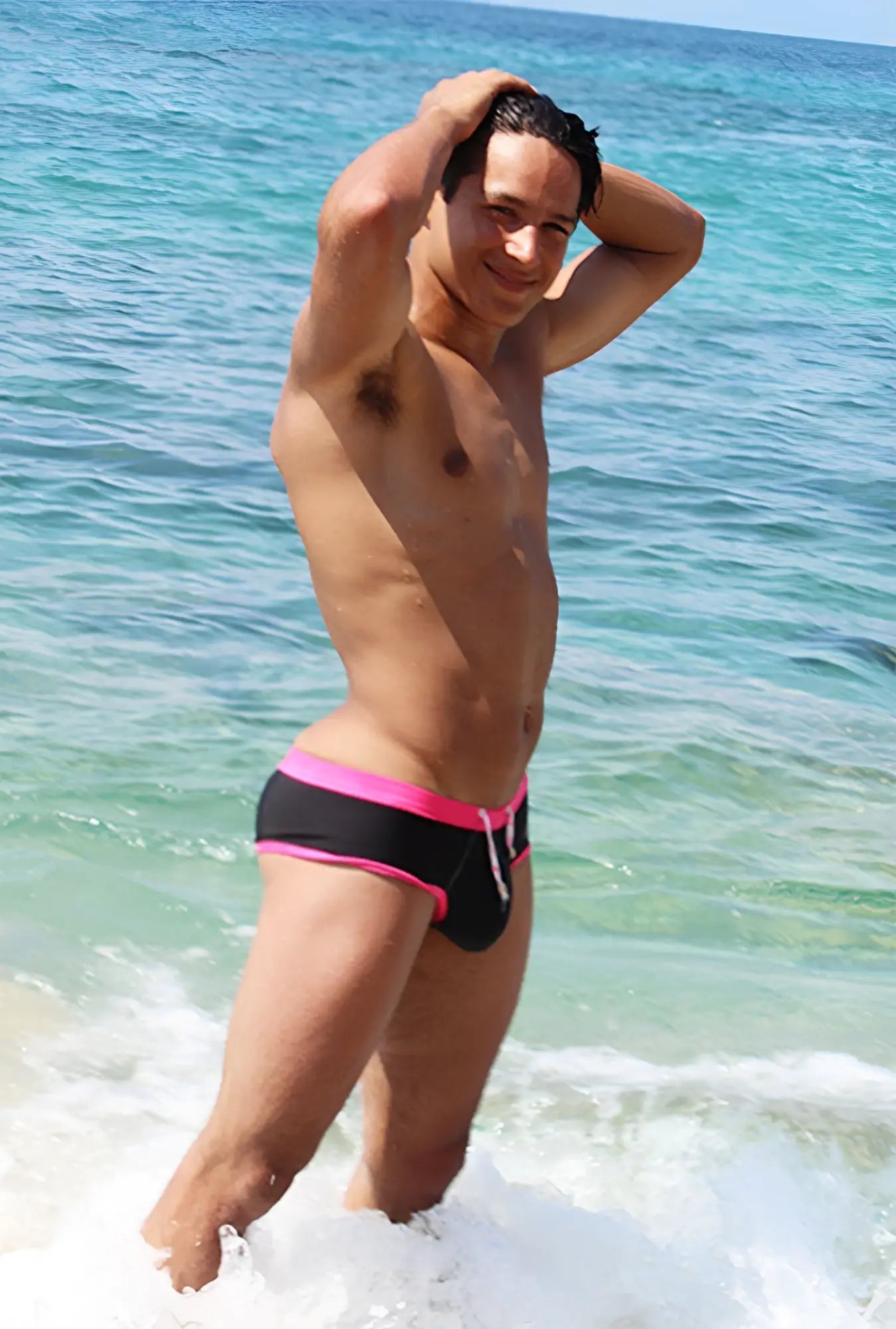 Black swim trunks with vibrant fuchsia trim and white drawstring from icker sea cheeky bikini swimwear collection