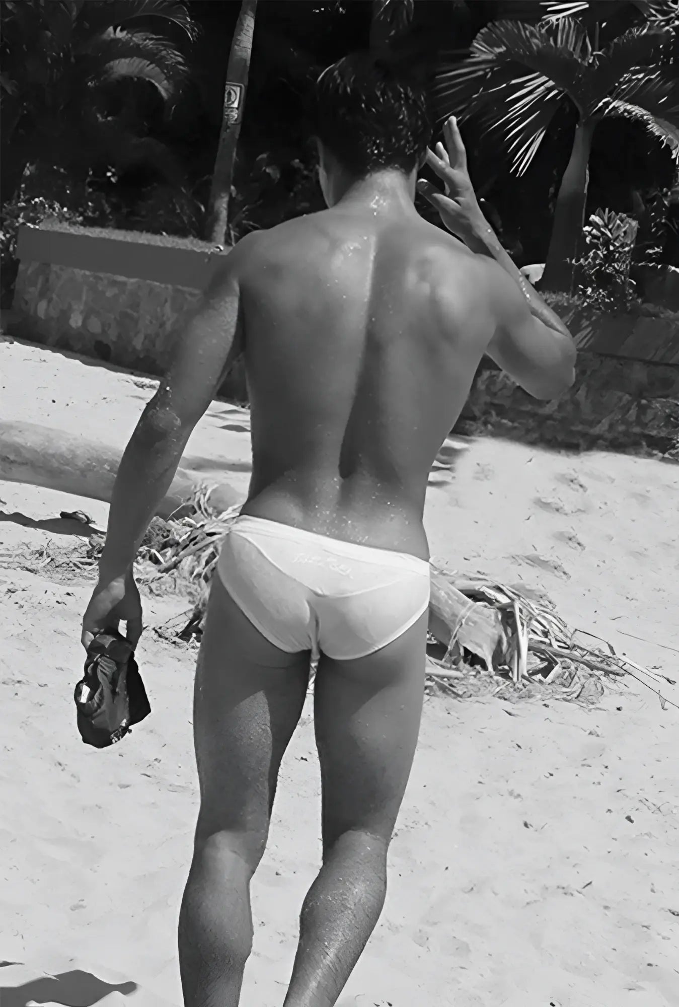 White briefs swimwear by icker sea duotone bikini swimwear red worn by a man on a beach front view