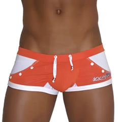 Icker Sea eyelets square cut trunk swimwear in orange and white with bold geometric pattern and brand logo on the side