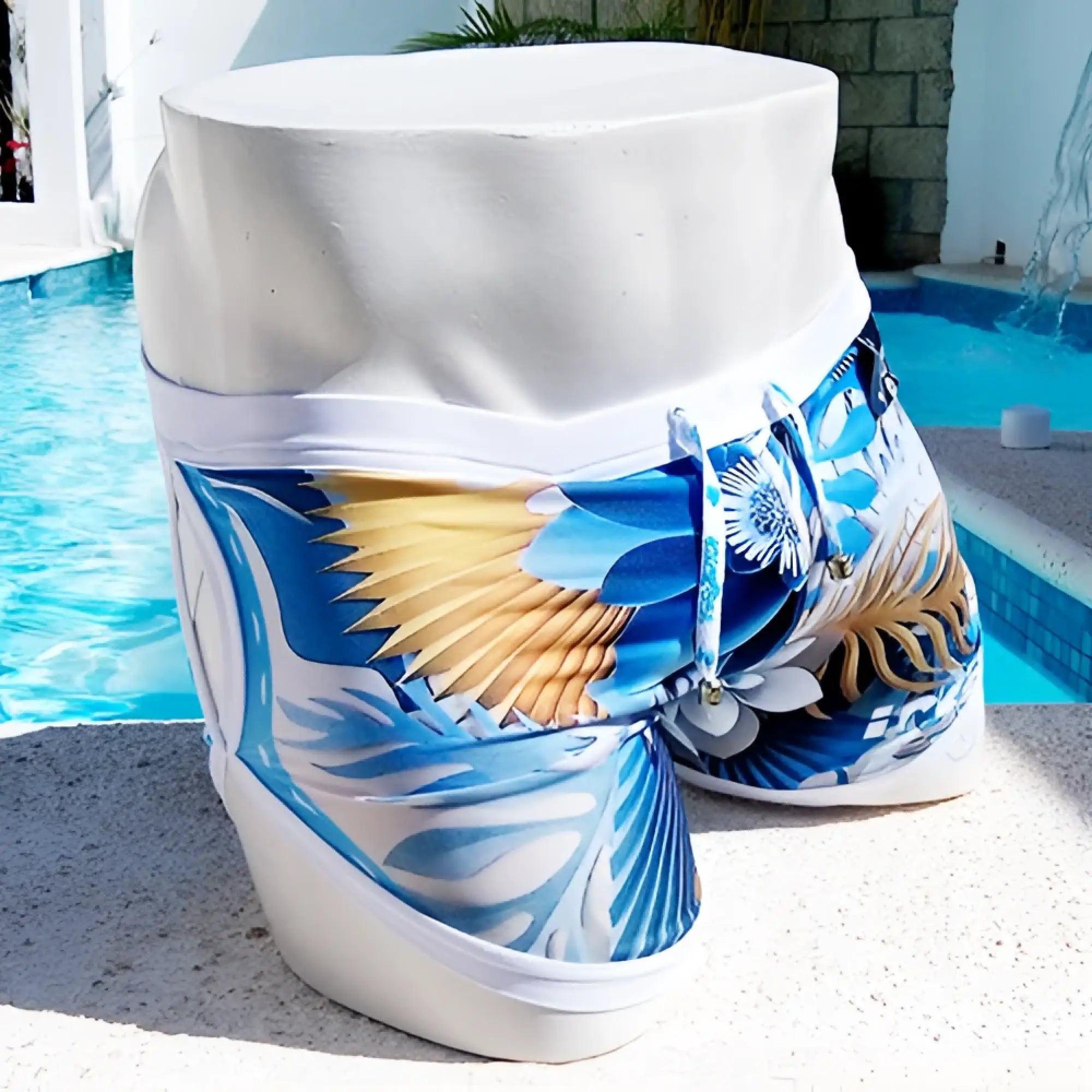 Icker Sea Greek Floral open side suspender scalloped shorts swimwear featuring blue and white tropical print with gold accents on a mannequin