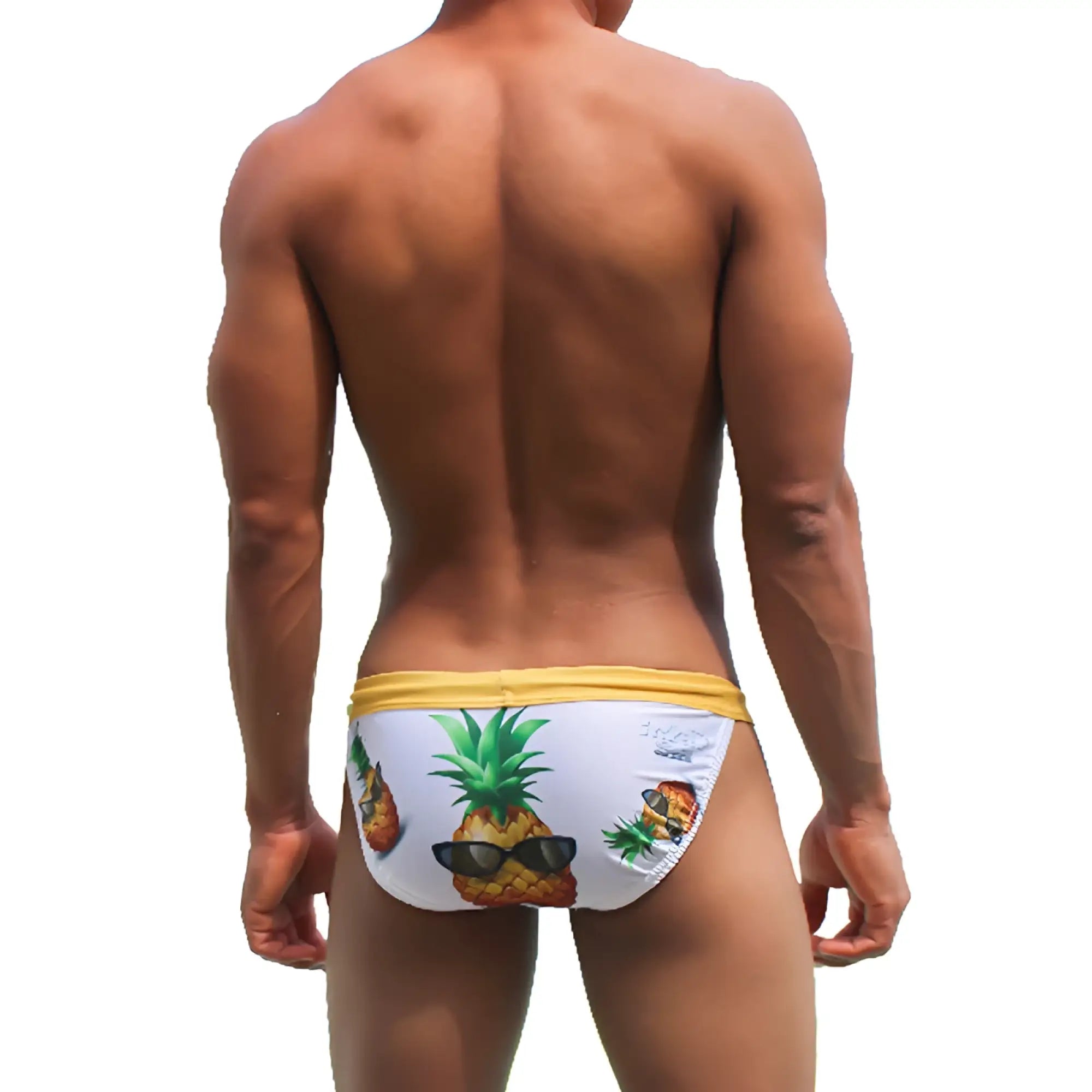 White swim trunks with yellow waistband and playful pineapple graphic wearing sunglasses for beachwear