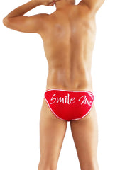 Red swim trunks with white cursive smile me text and thin white trim from icker sea slip bikini underwear collection