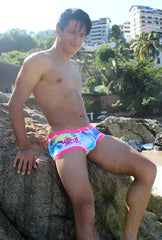 Vibrant multicolored icker sea spring square cut trunk swimwear with tropical print and bright pink trim in pink blue