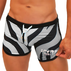 Icker Sea zebra open side suspender scalloped swim trunks in black and white zebra stripes with blue drawstring ties