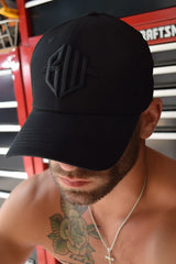 Black baseball cap with subtle raised geometric logo embroidered in matching black thread, ICON cap black