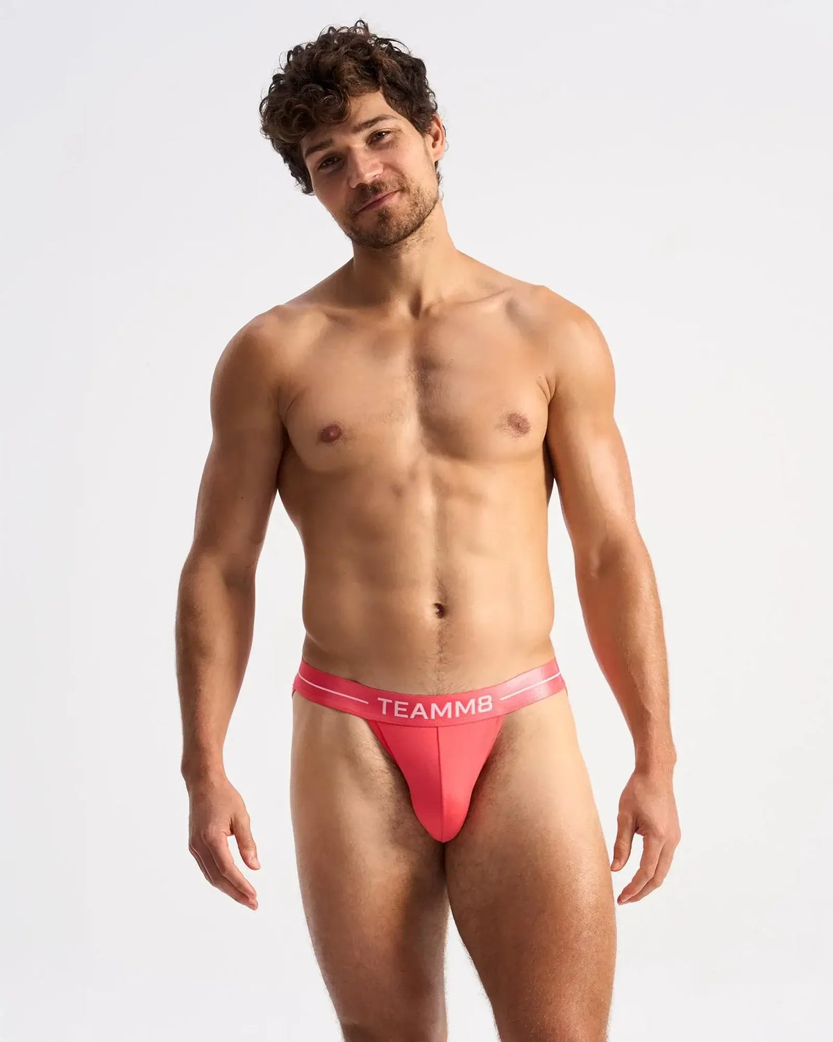 Vibrant coral-colored teammb icon sports brief with sleek form-fitting design for active performance wear