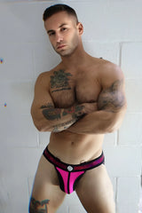 Bright pink and black athletic briefs with shiny metallic trim from illuminator jock shown from the front side