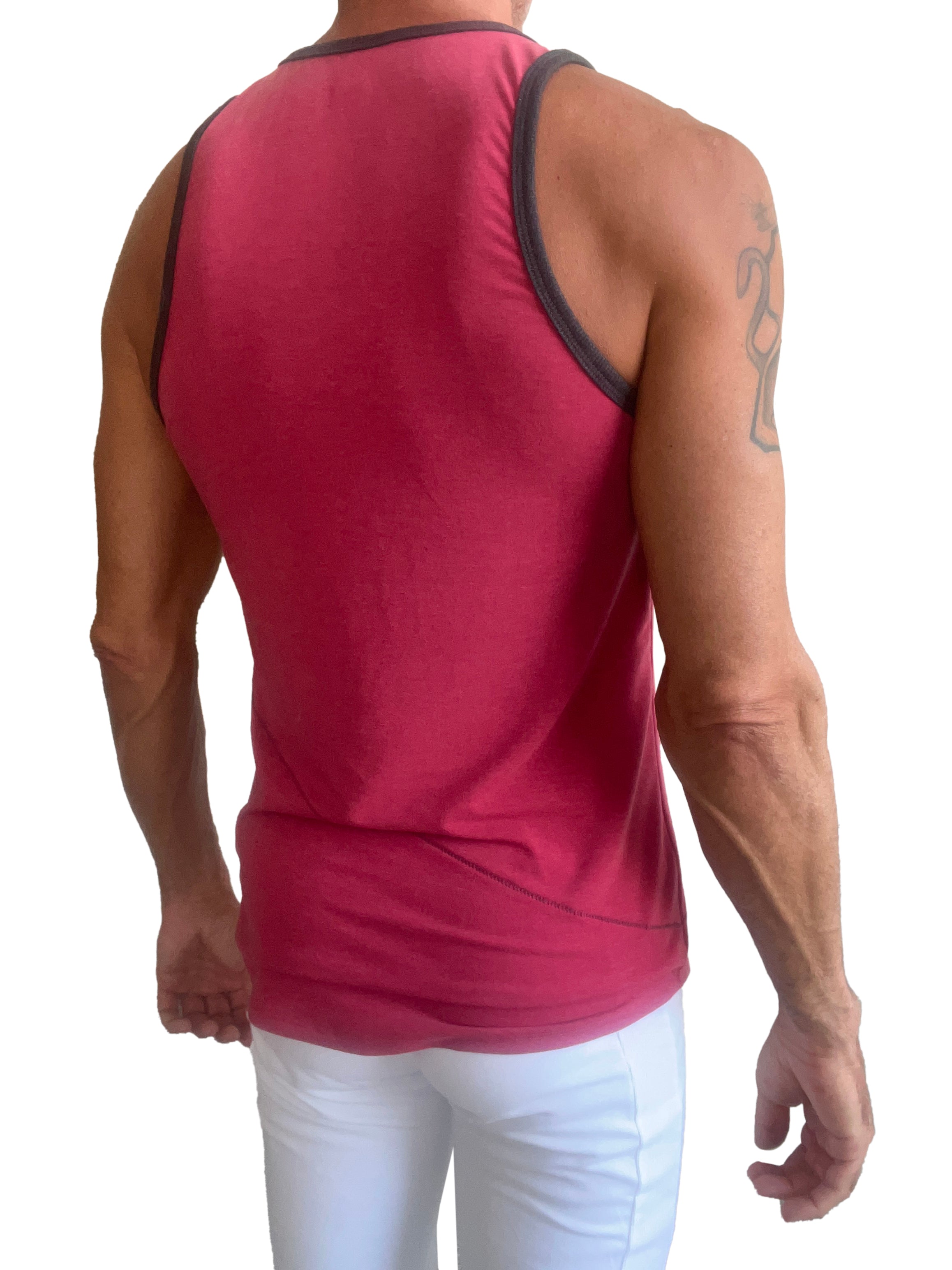 A vibrant raspberry sleeveless tank top with black trim on neckline and armholes called the perfect tank