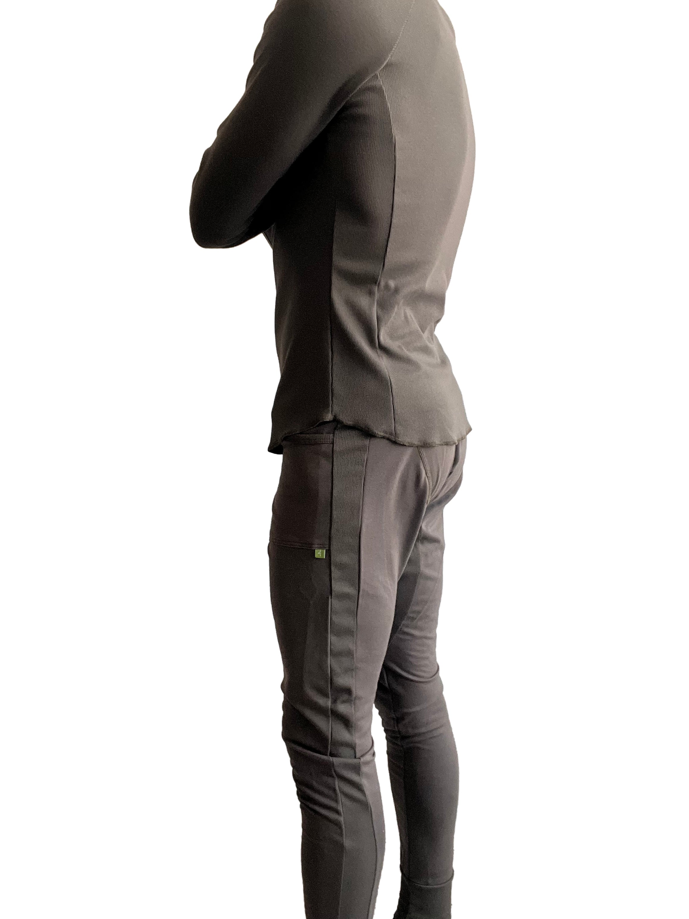 A sleek charcoal gray two-piece athletic set with fitted long-sleeve top and slim-fit pants with vertical seams