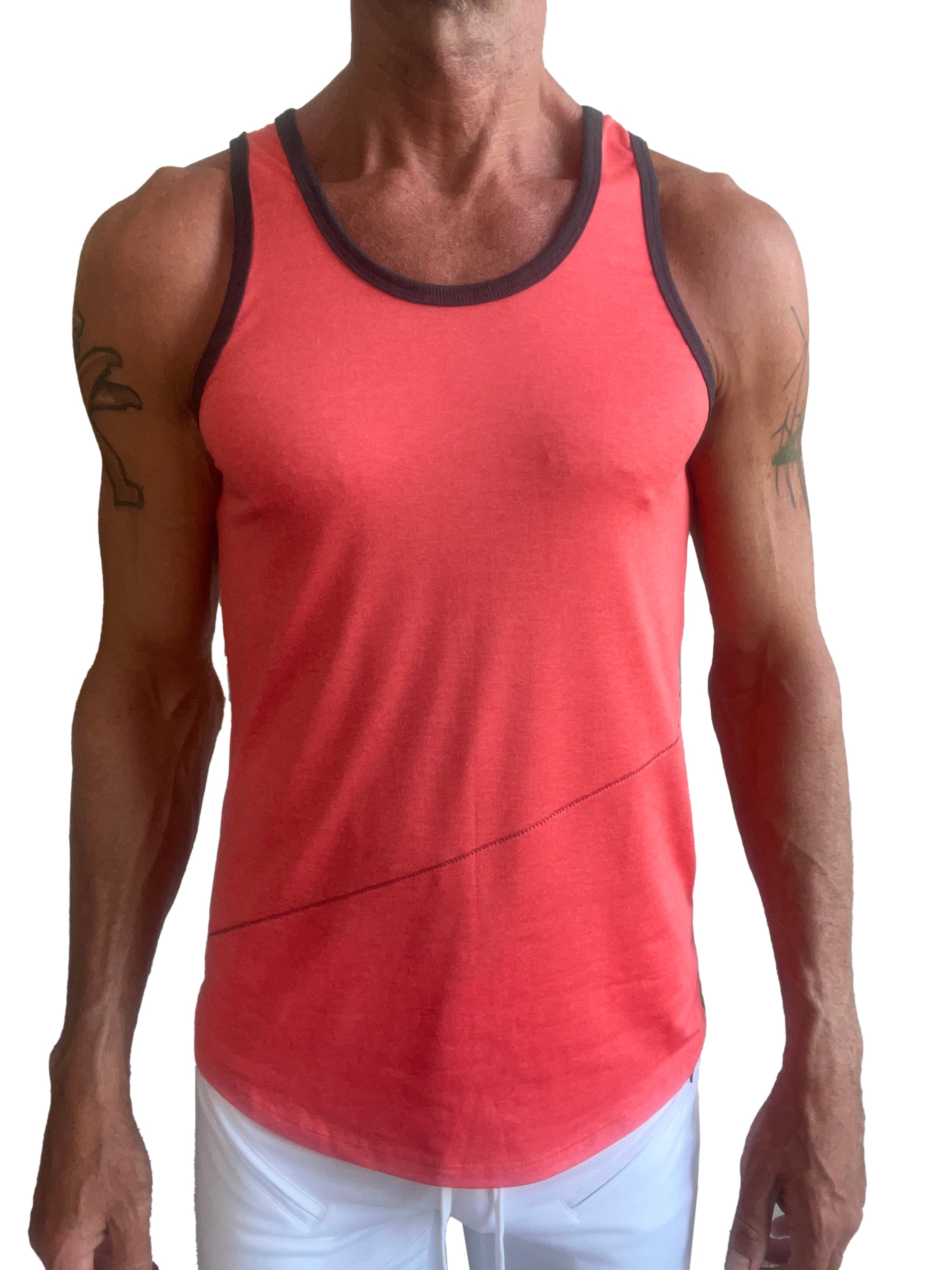 A coral tank top called the perfect tank with black trim and a subtle diagonal seam detail