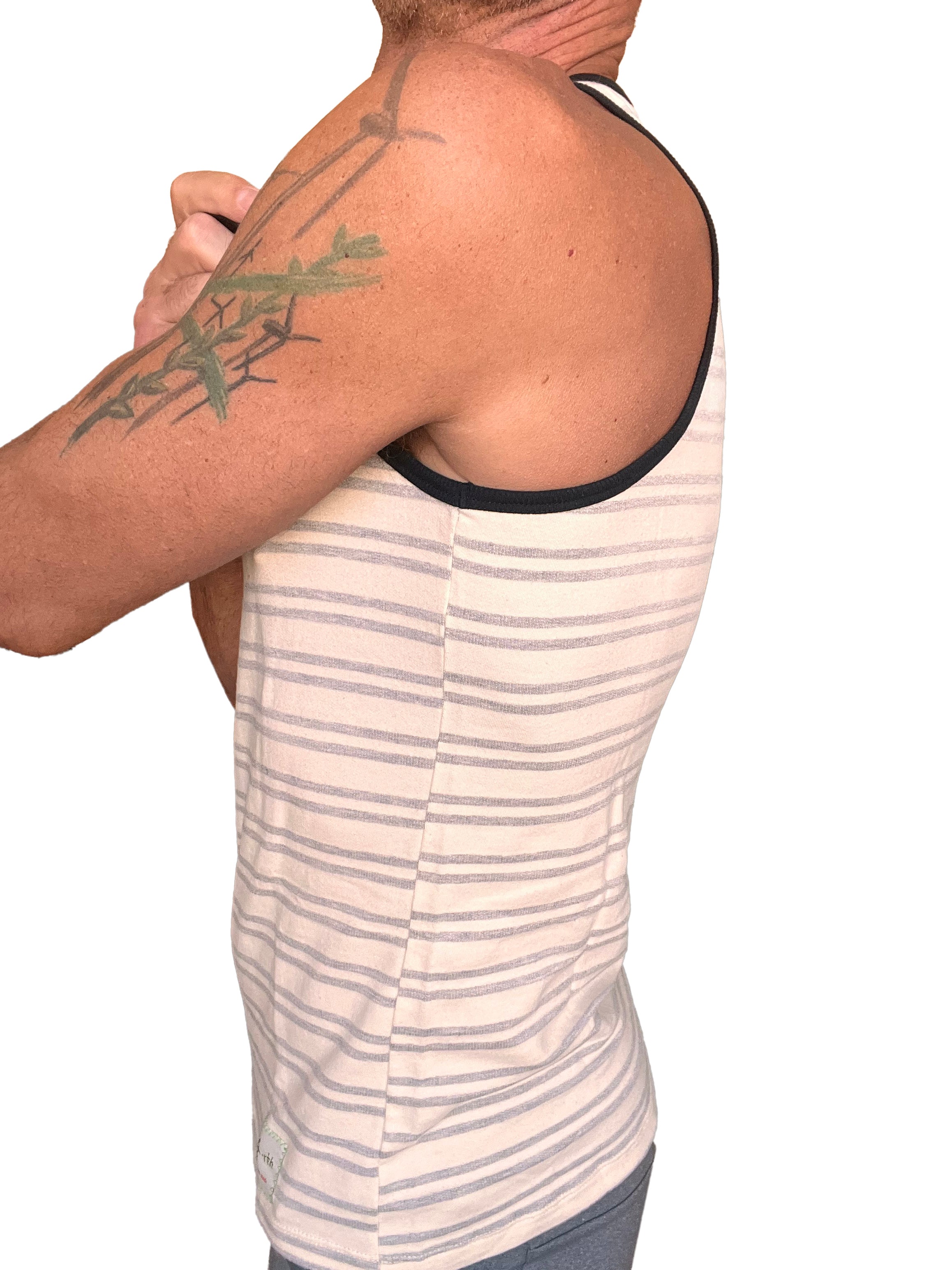 A man wearing a light gray stripe yummy nautical fleece sustain tank top with beige and gray stripes and black trim