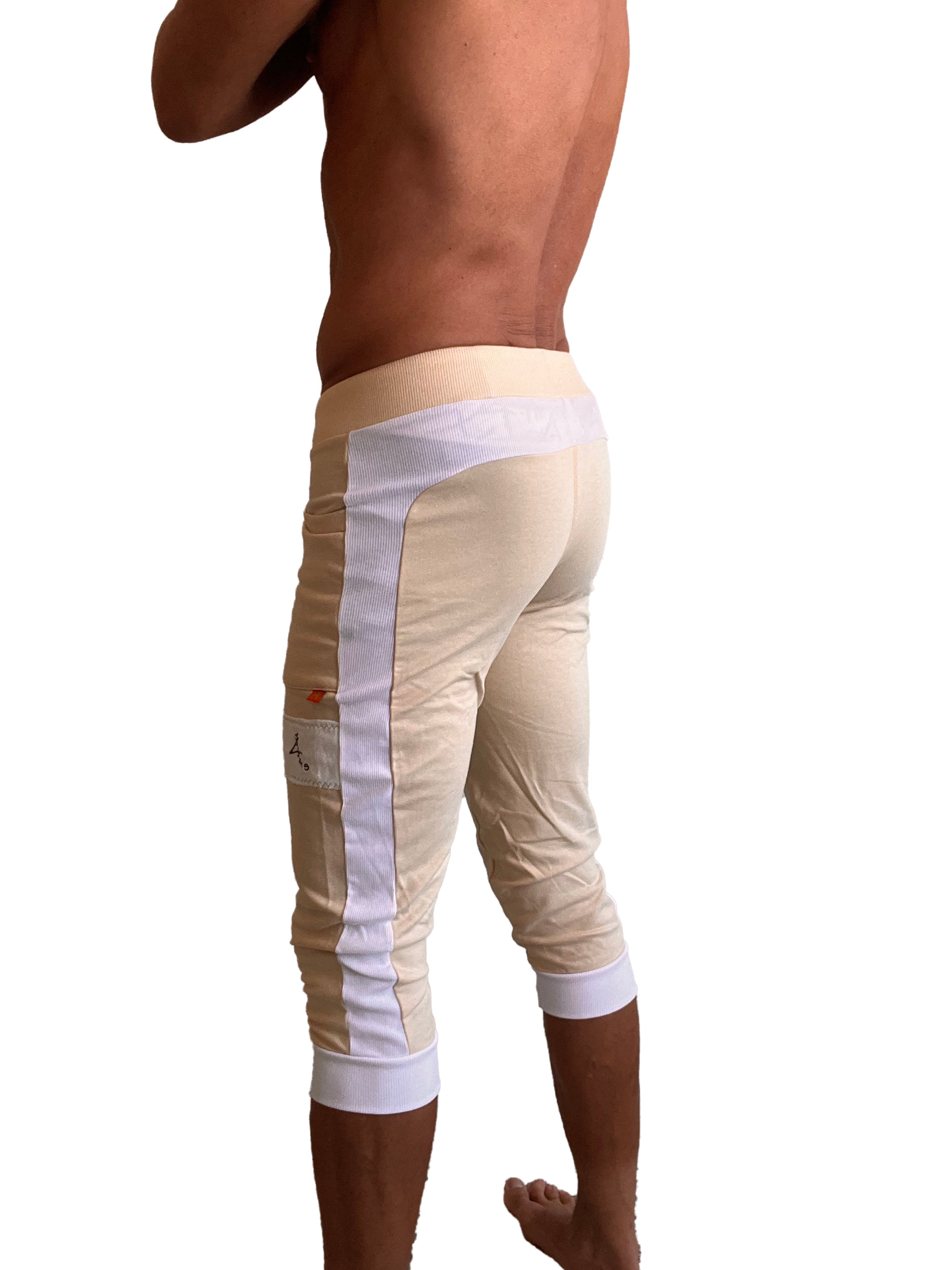 Beige edge cuffed yoga capri pants with white mesh side panels and elastic cuffs for athletic wear