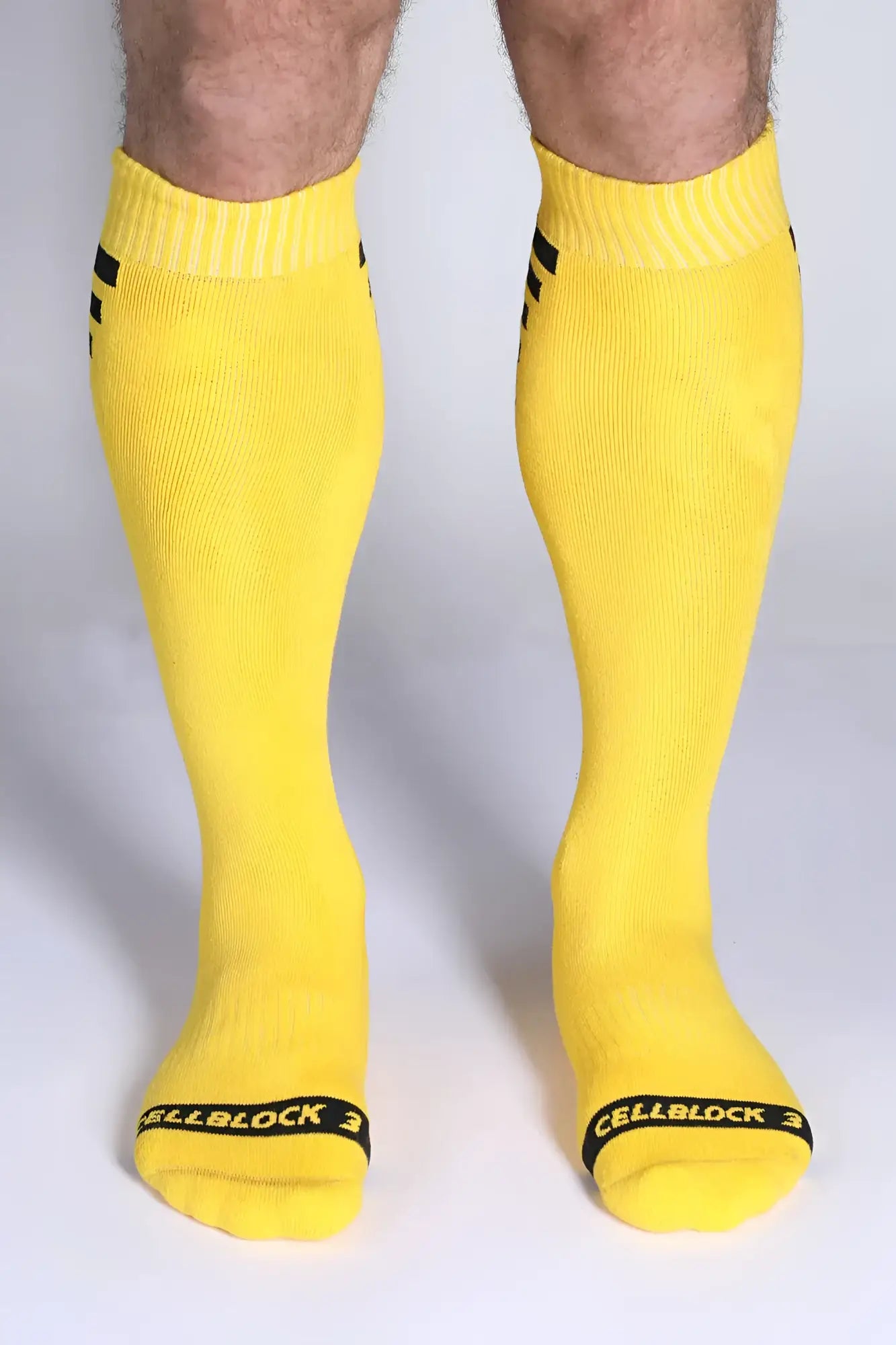 Iron grip knee high socks bright yellow with black cuff stripes and cellblock 3 branding at the toe