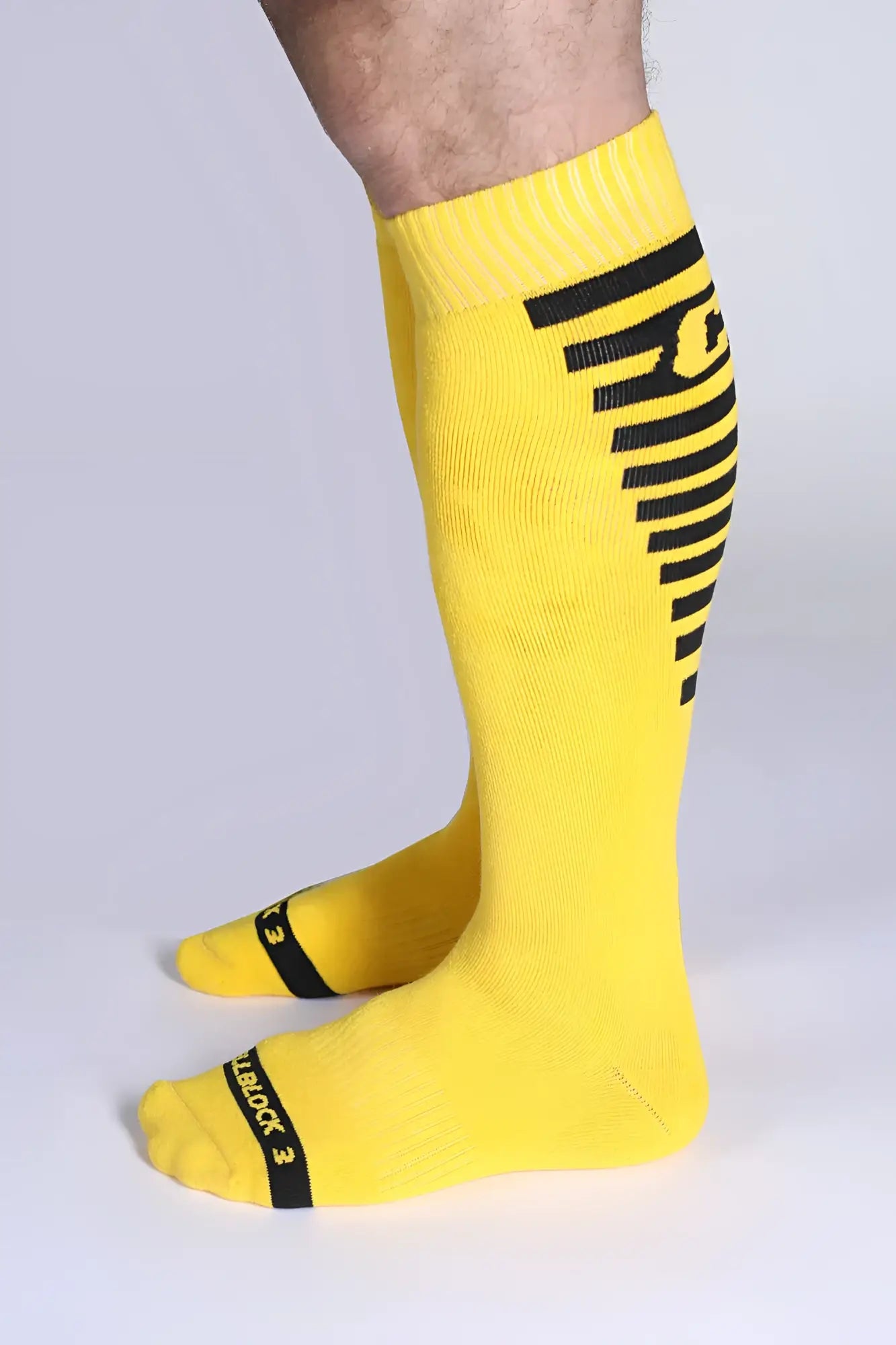 Iron grip knee high socks in bright yellow with bold black stripes and reinforced toe caps for durability