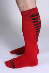 Iron grip knee high sock in red with black horizontal stripes and logo on the side for athletic support
