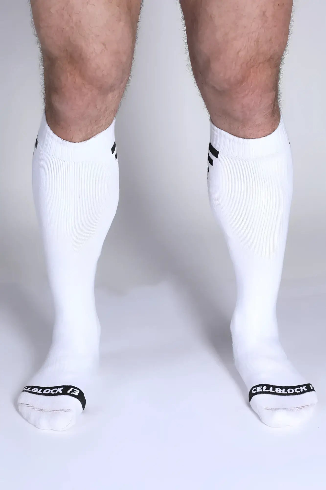 Iron Grip knee high socks in white with black cuff stripes and cellblock 13 branding on the toe