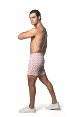 Men’s jacquard printed stretch knit short swim trunks in pink and white with geometric pattern for beachwear