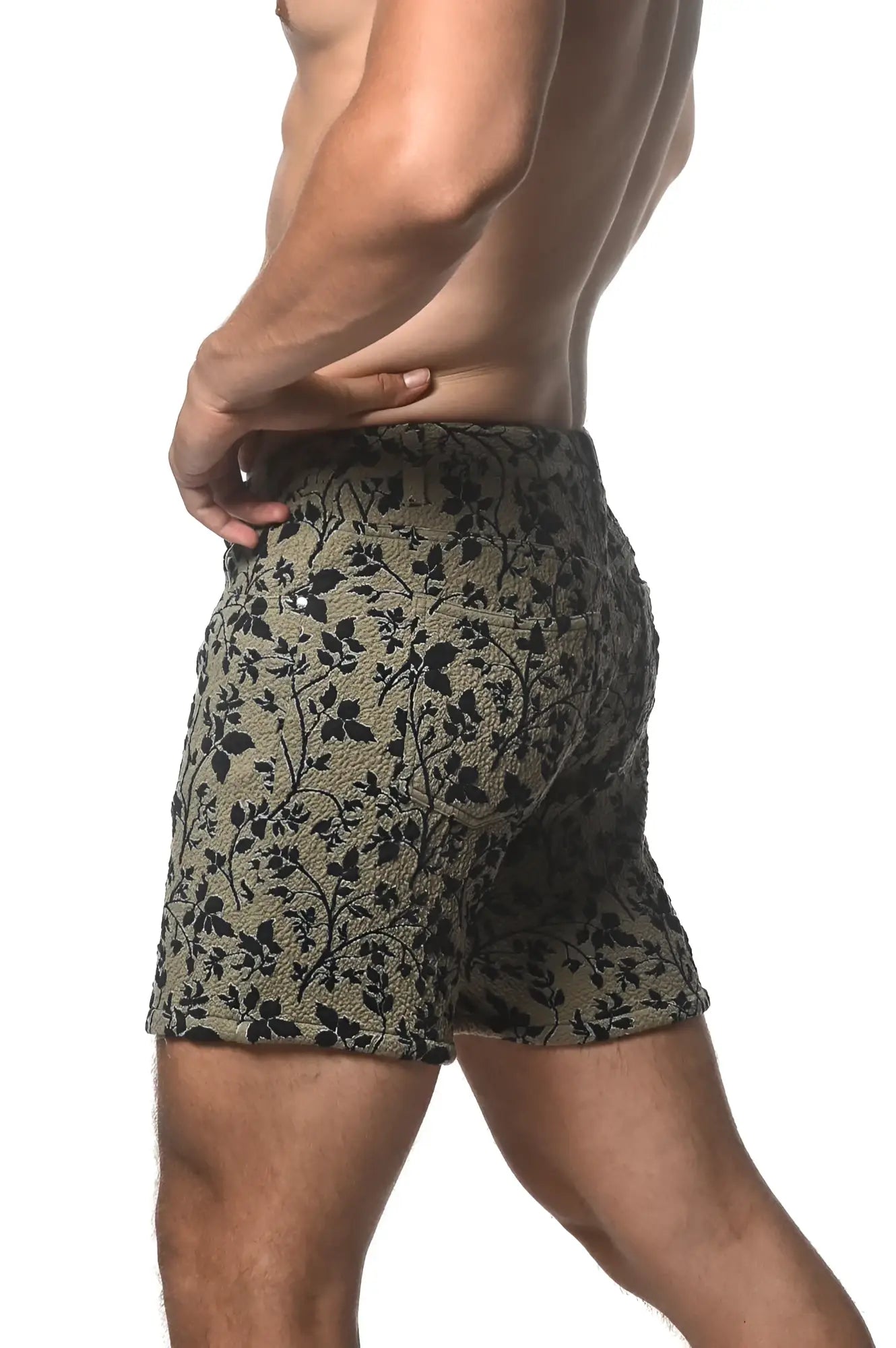 Olive green jacquard printed stretch knit shorts with black floral pattern and textured fabric front view