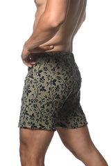 Olive green jacquard printed stretch knit shorts with black floral pattern and textured fabric front view