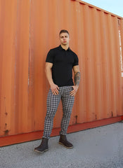 Black short-sleeved polo shirt with classic collar and fitted cut paired with Jed North Embassy Grid Pants grey size M