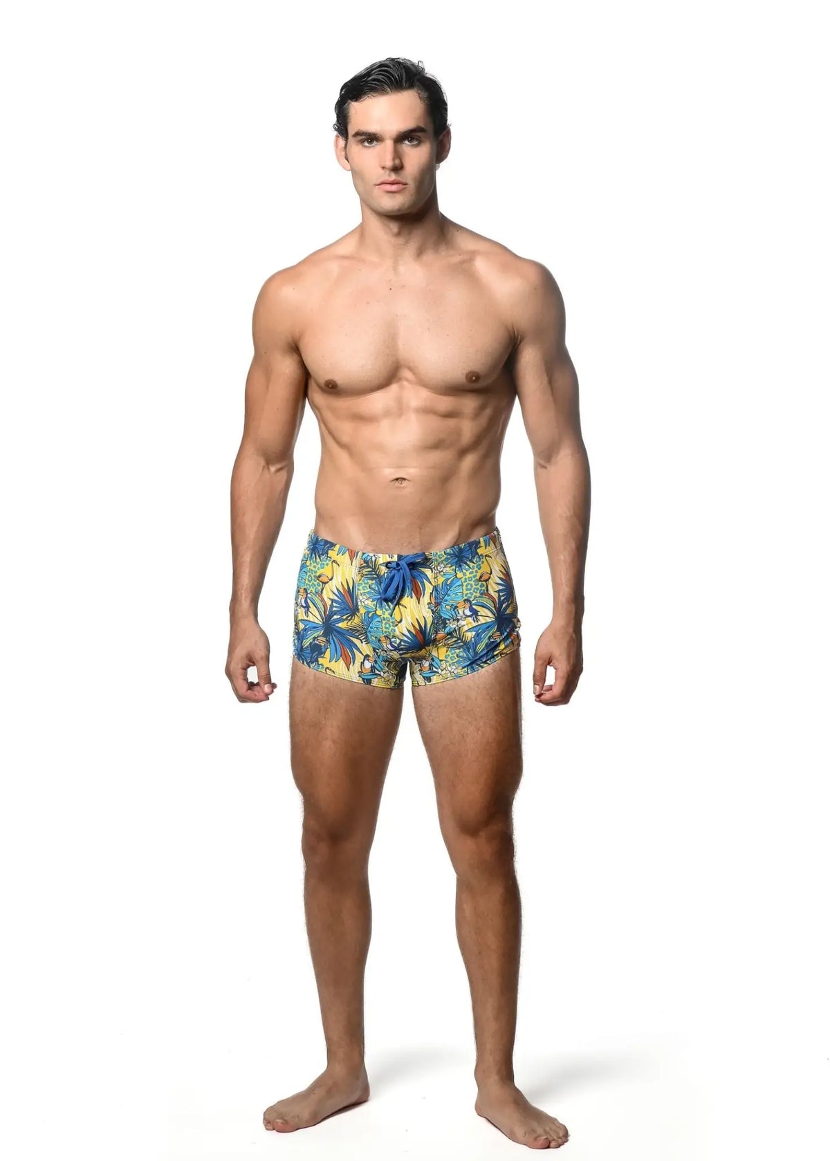 Men’s jungle printed swim trunk with vibrant yellow and blue tropical leaf pattern perfect for beachwear