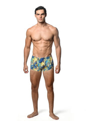 Men’s jungle printed swim trunk with vibrant yellow and blue tropical leaf pattern perfect for beachwear