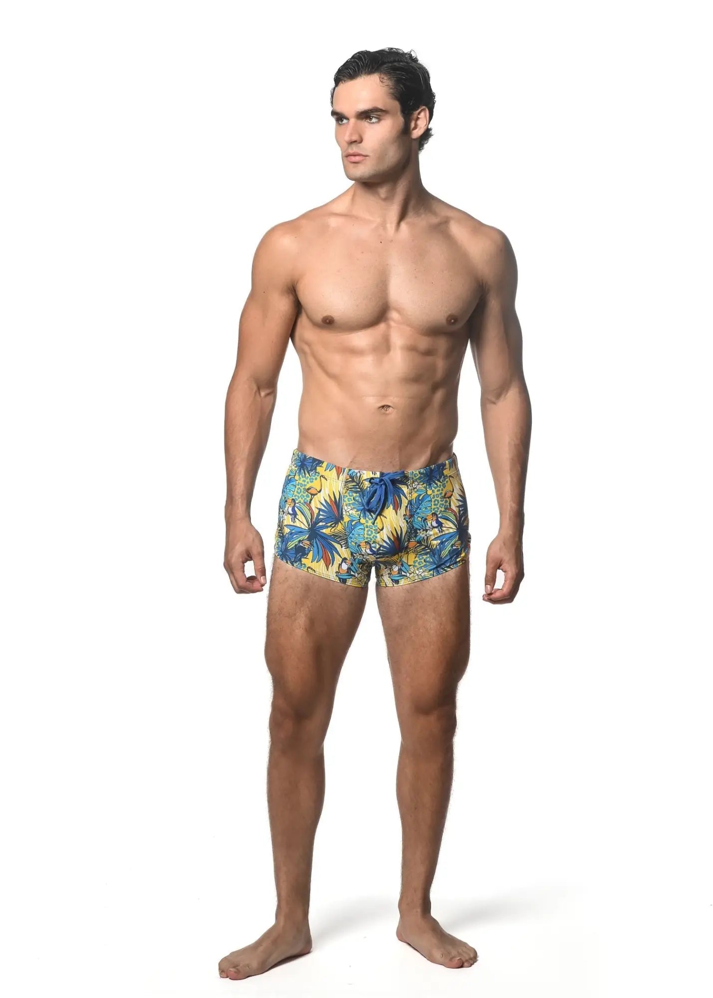 Men’s jungle printed swim trunk with vibrant blue and yellow tropical leaf pattern for beach and pool use