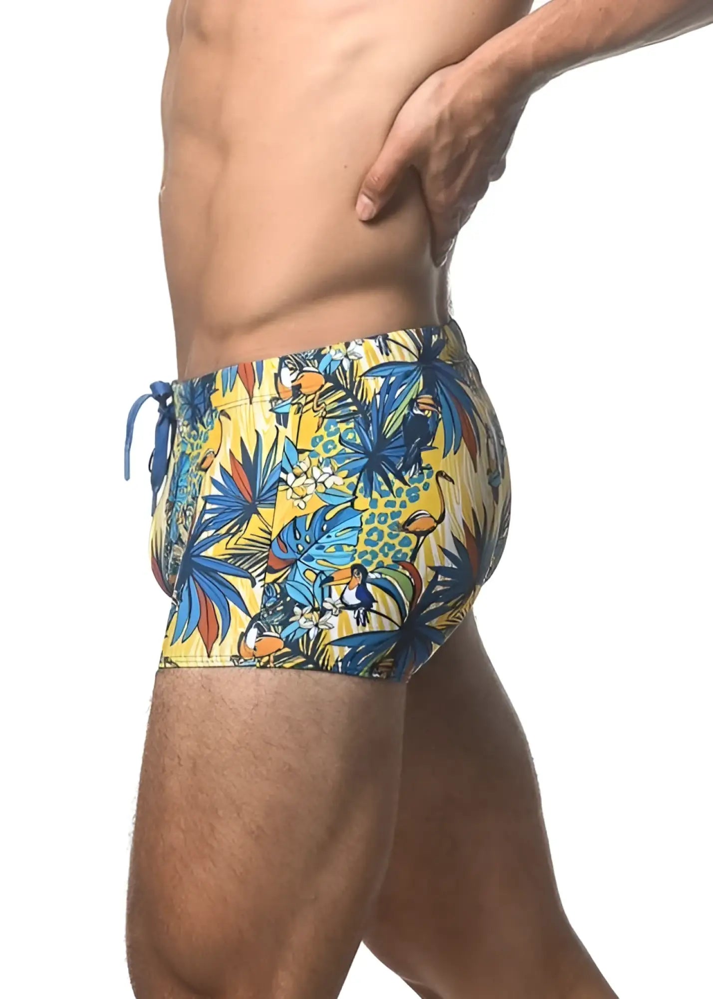 Vibrant yellow jungle printed swim trunk with tropical toucan and palm leaf pattern perfect for beachwear