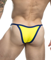 Bright yellow thong with navy blue trim from the justin + simon bikini one collection