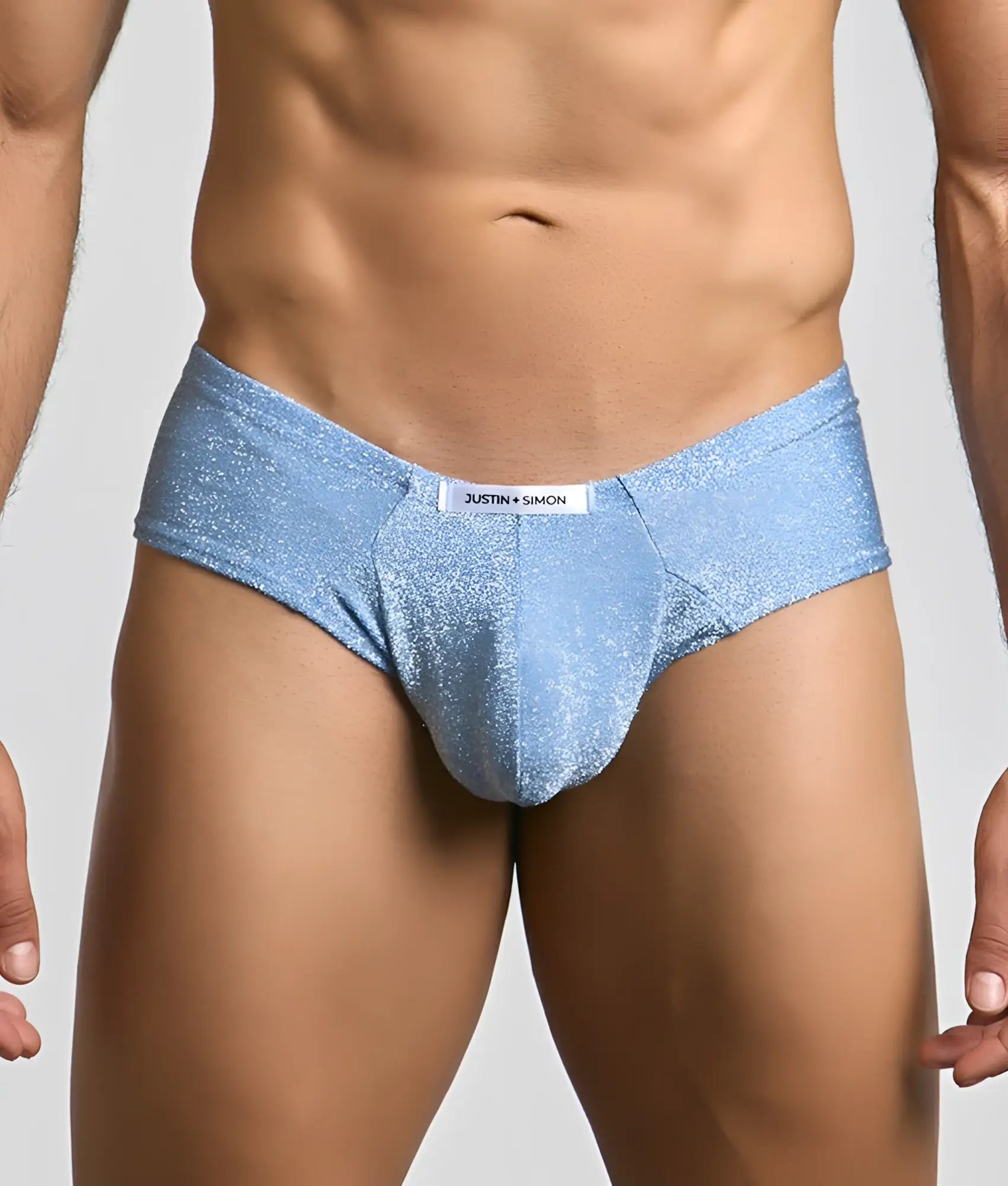 Light blue glittery fabric briefs with a white justin plus simon label at the waistband from the cheek collection