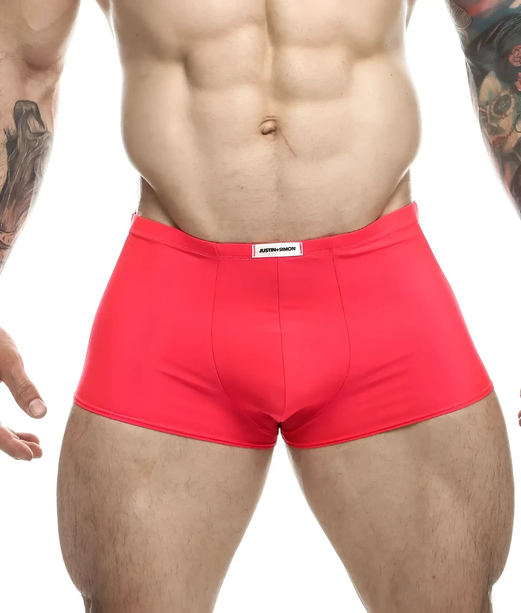 Bright red form-fitting briefs with a white justin simon label at the waistband from the Justin plus Simon classic boxer line