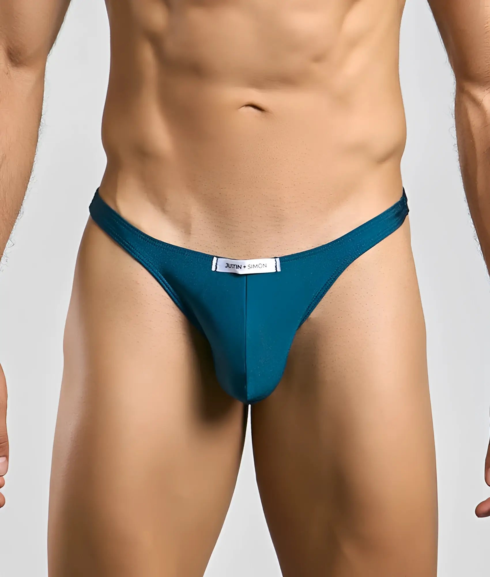 Teal-colored justin and simon classic tanga thong with sleek form-fitting design shown from the back side