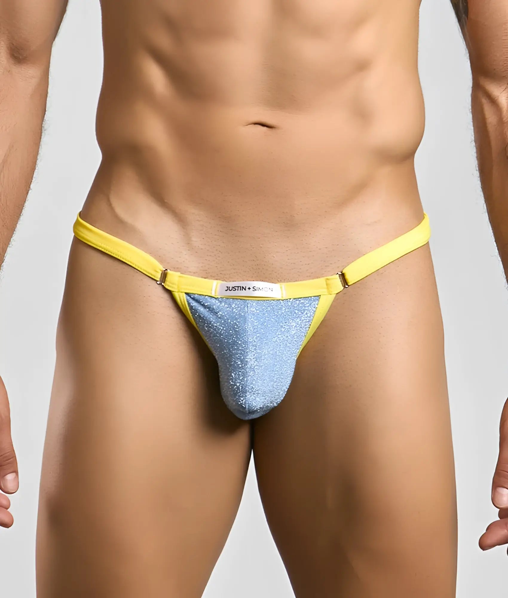 Bright yellow and shimmering blue glittery thong from justin plus simon bikini one with visible brand label