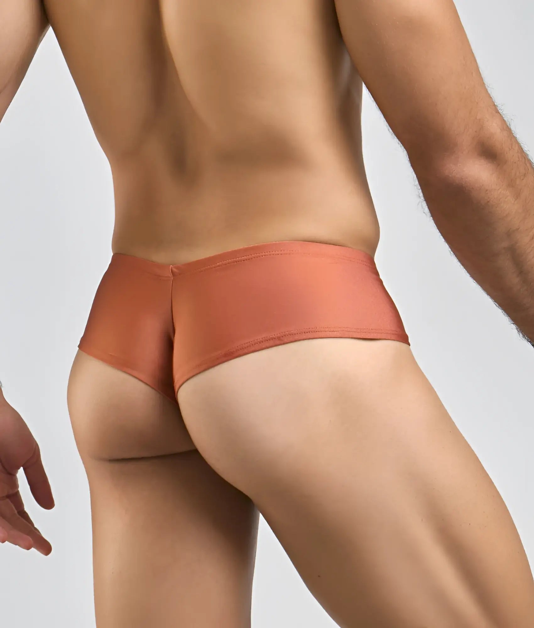 Coral-colored sleek-fitting mens briefs by justin simon cheek made of smooth stretchy fabric for comfort and support