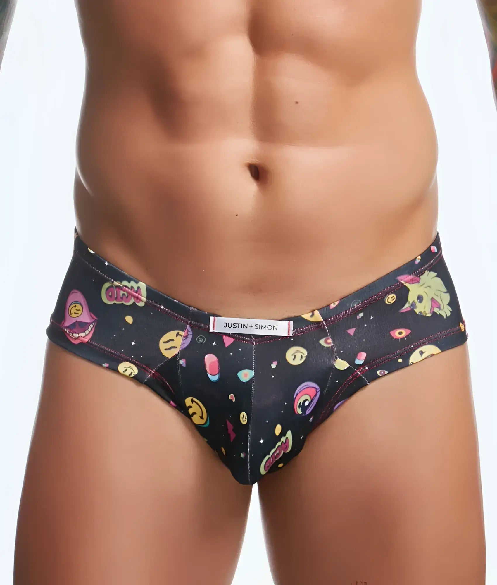 Black men’s briefs by Justin plus Simon with vibrant cartoonish space-themed pattern and colorful cosmic emojis