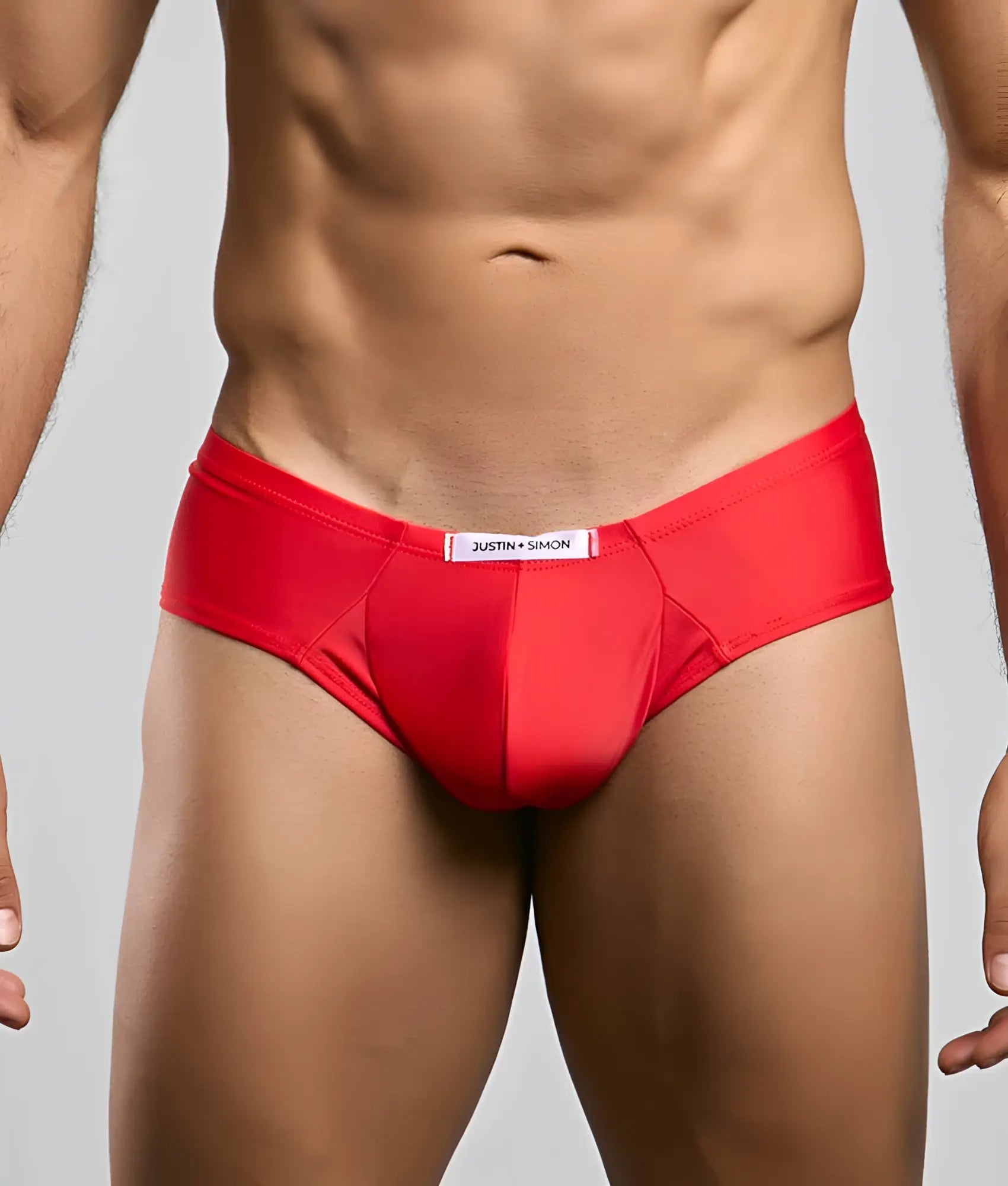 Red justin simon cheek briefs feature a smooth form fitting design with a white waistband label