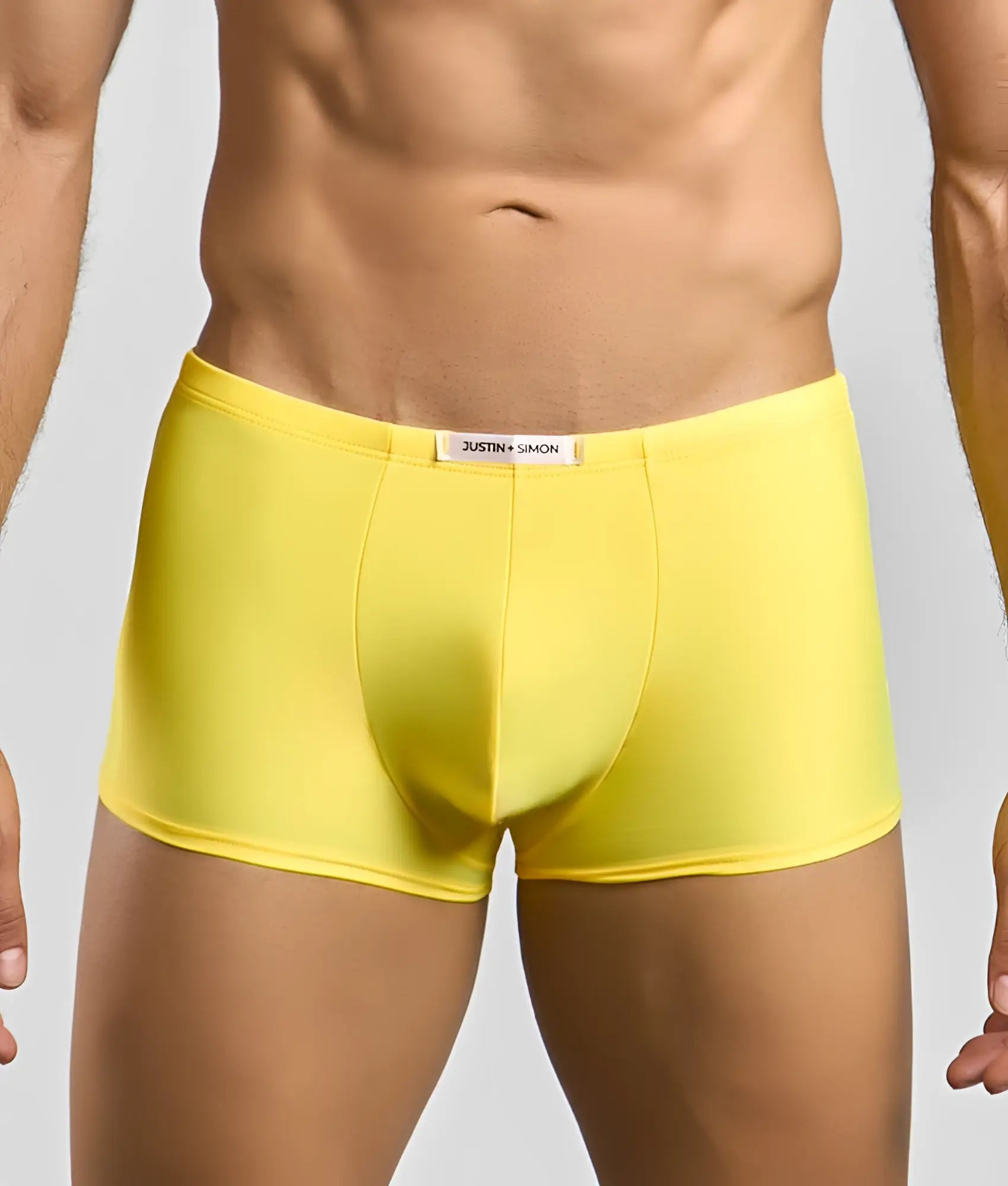 Bright yellow justin simon classic boxer briefs with smooth form fitting fabric and white brand tag on waistband