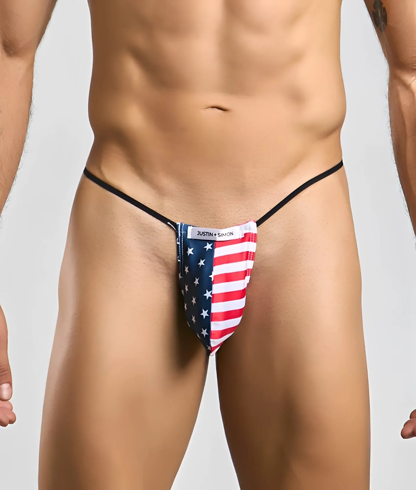 Justin simon classic g-string bulge featuring american flag-themed red white stripes and blue stars on stretchy fabric