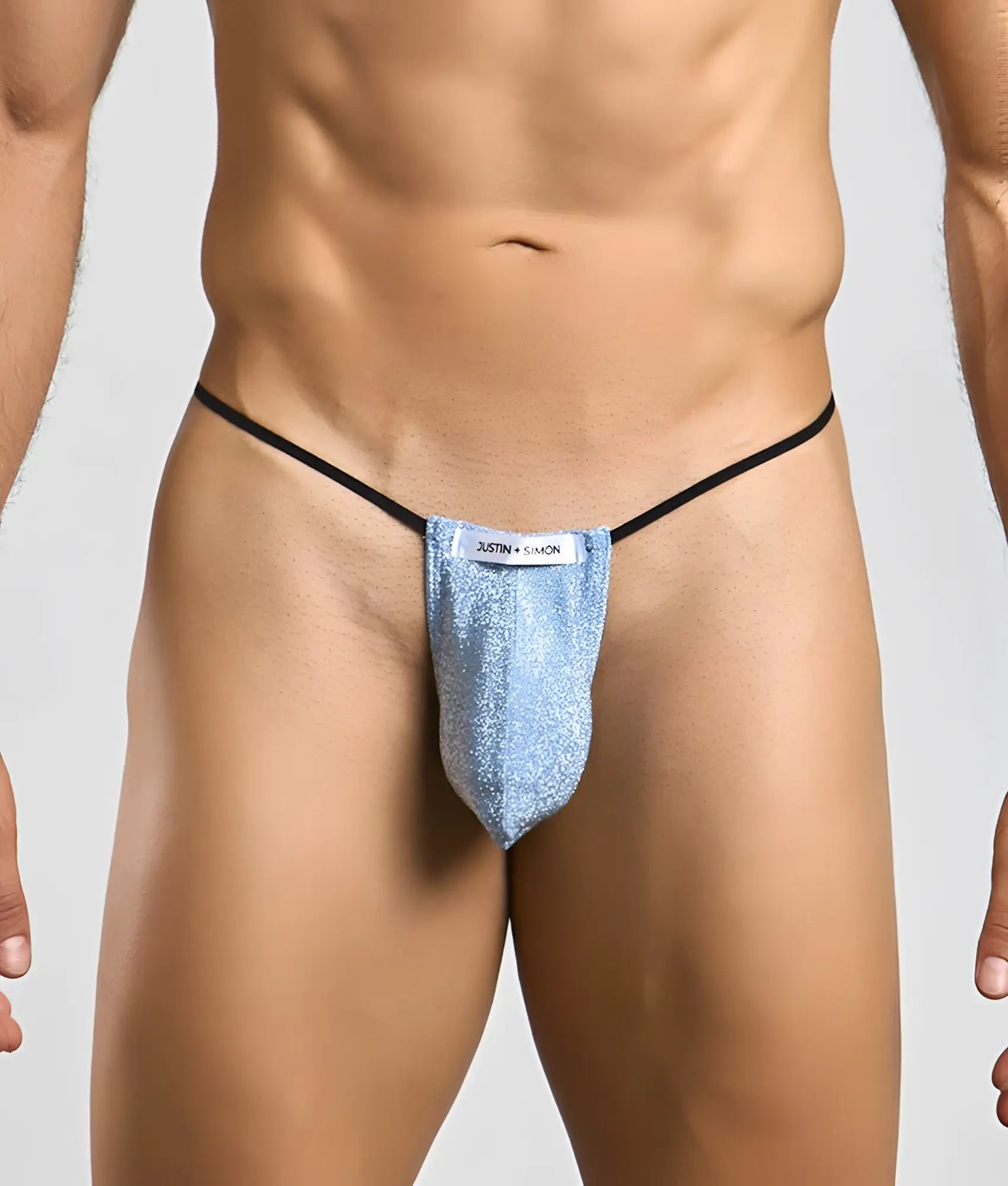 Justin and Simon classic g-string bulge in shimmering light blue glitter with black elastic straps and white label
