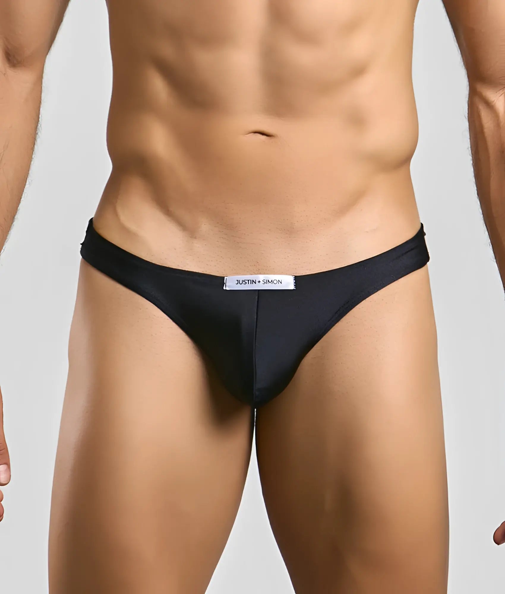 Black justin simon classic mens bikini briefs with a sleek form-fitting design and subtle brand tag at the waistband