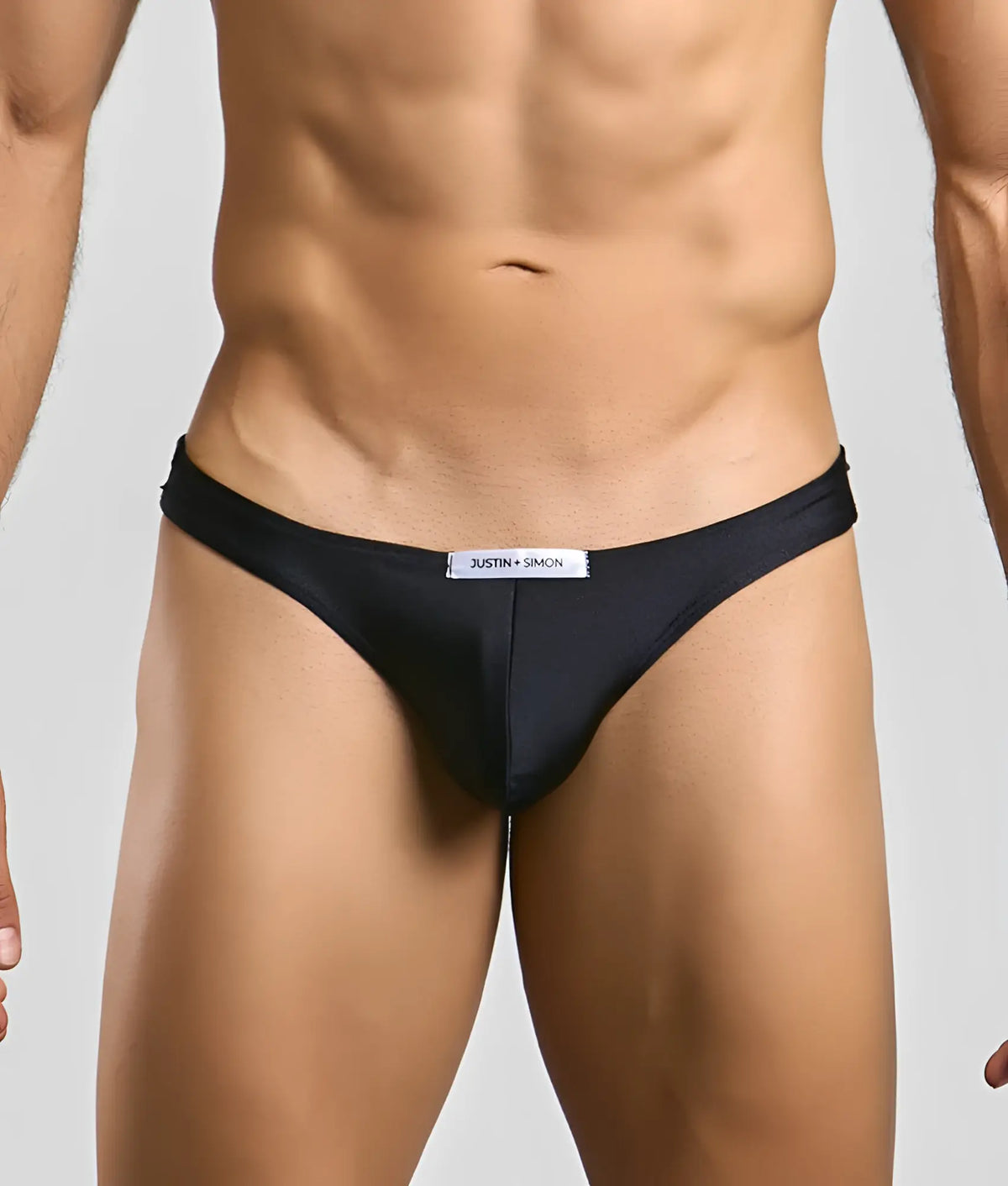 Black justin simon classic mens bikini briefs with a sleek form-fitting design and subtle brand tag at the waistband