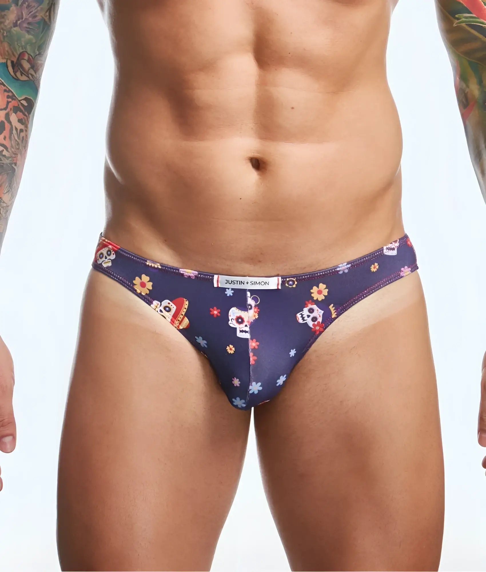 Dark blue mens briefs with vibrant sugar skull and floral print featuring justin simon waistband branding