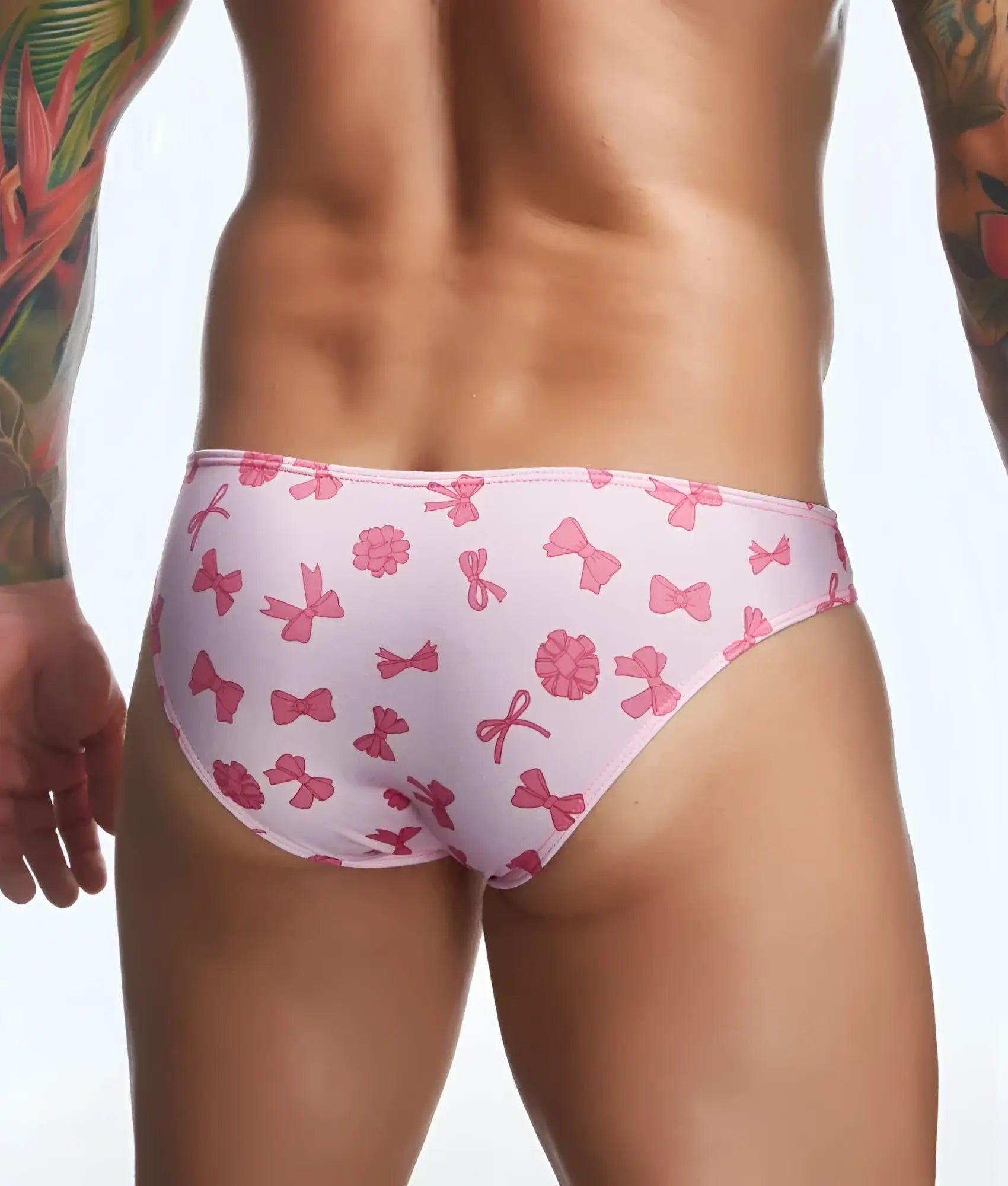 Justin plus Simon classic mens bikini swim trunks with pink bow and flower print for fun beachwear use