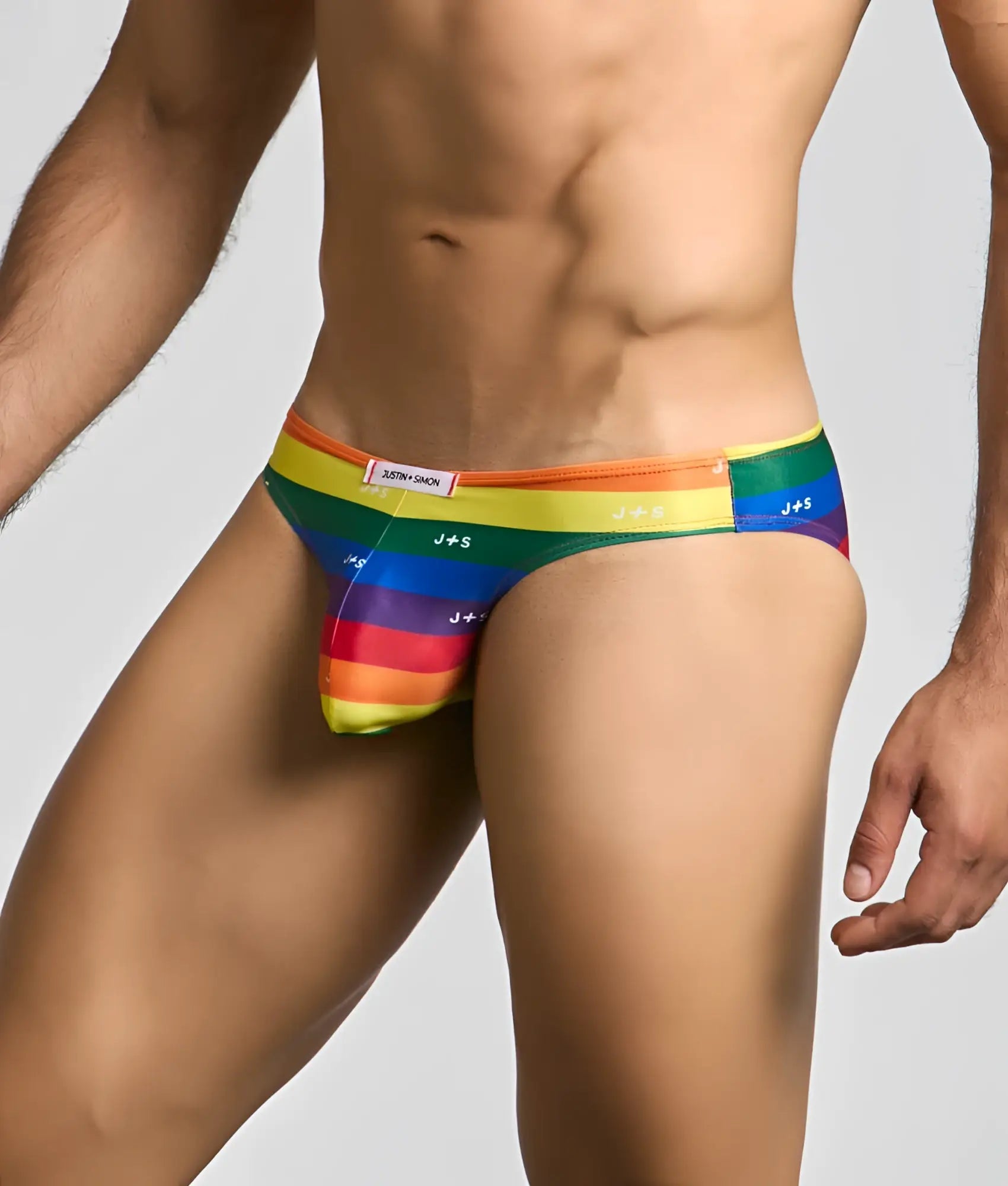 Rainbow-striped men’s briefs with j+s branding and a snug form-fitting design from justin + simon classic mens bikini