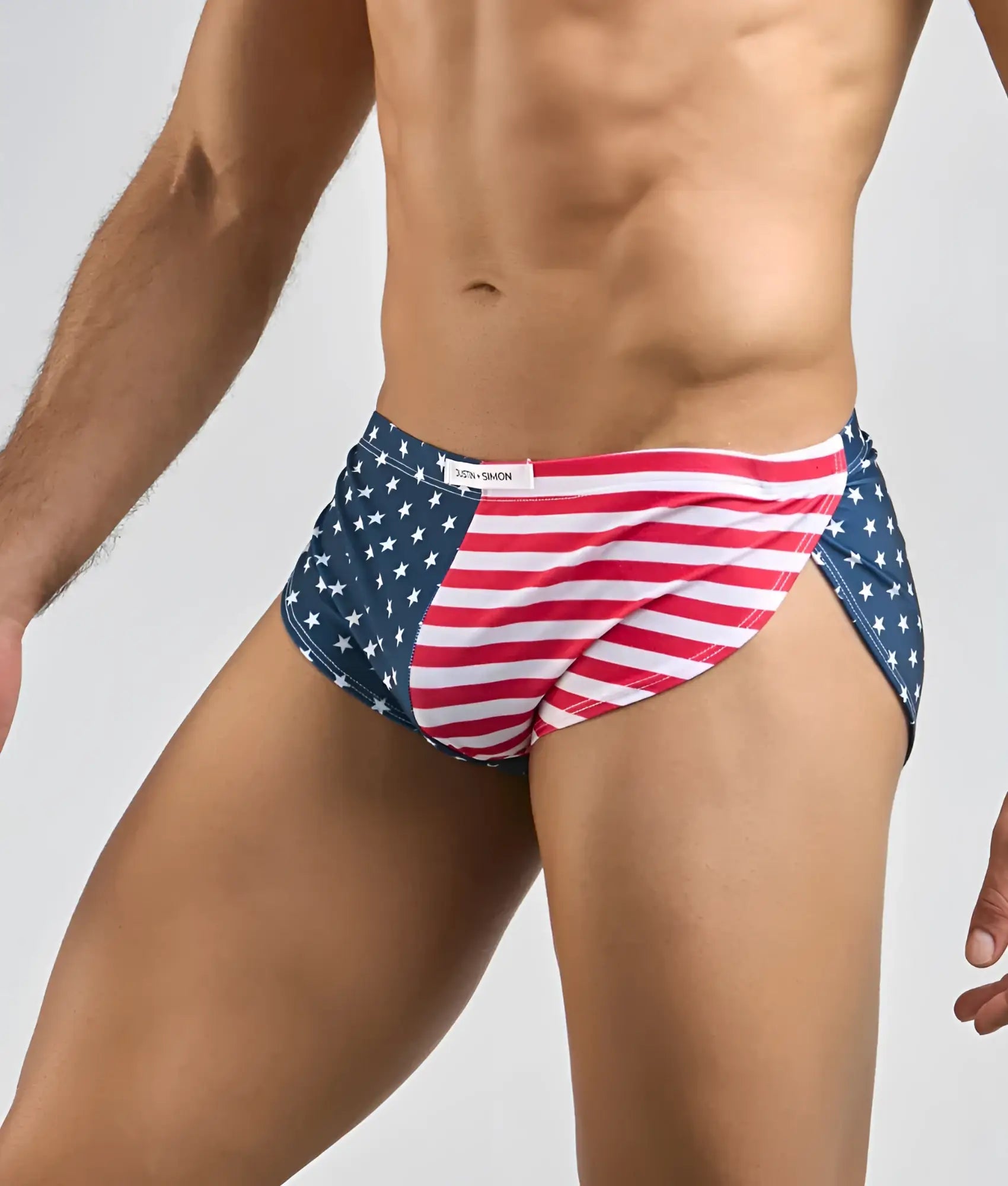 Justin + Simon running short men’s swim trunks in red white and blue with American flag star-spangled design