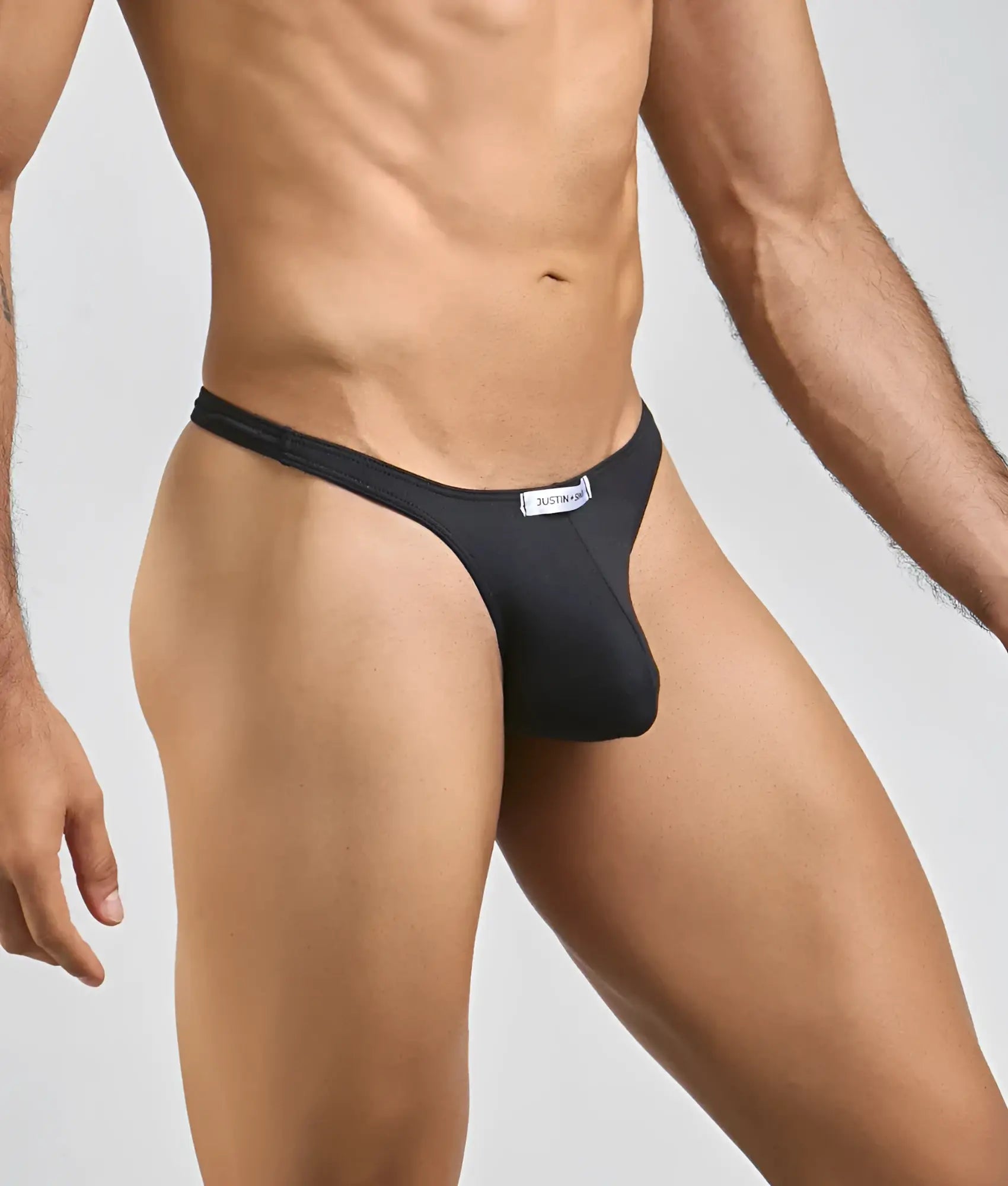 Black justbronze thong made of smooth form-fitting fabric with sleek design and minimalistic waistband showing back side