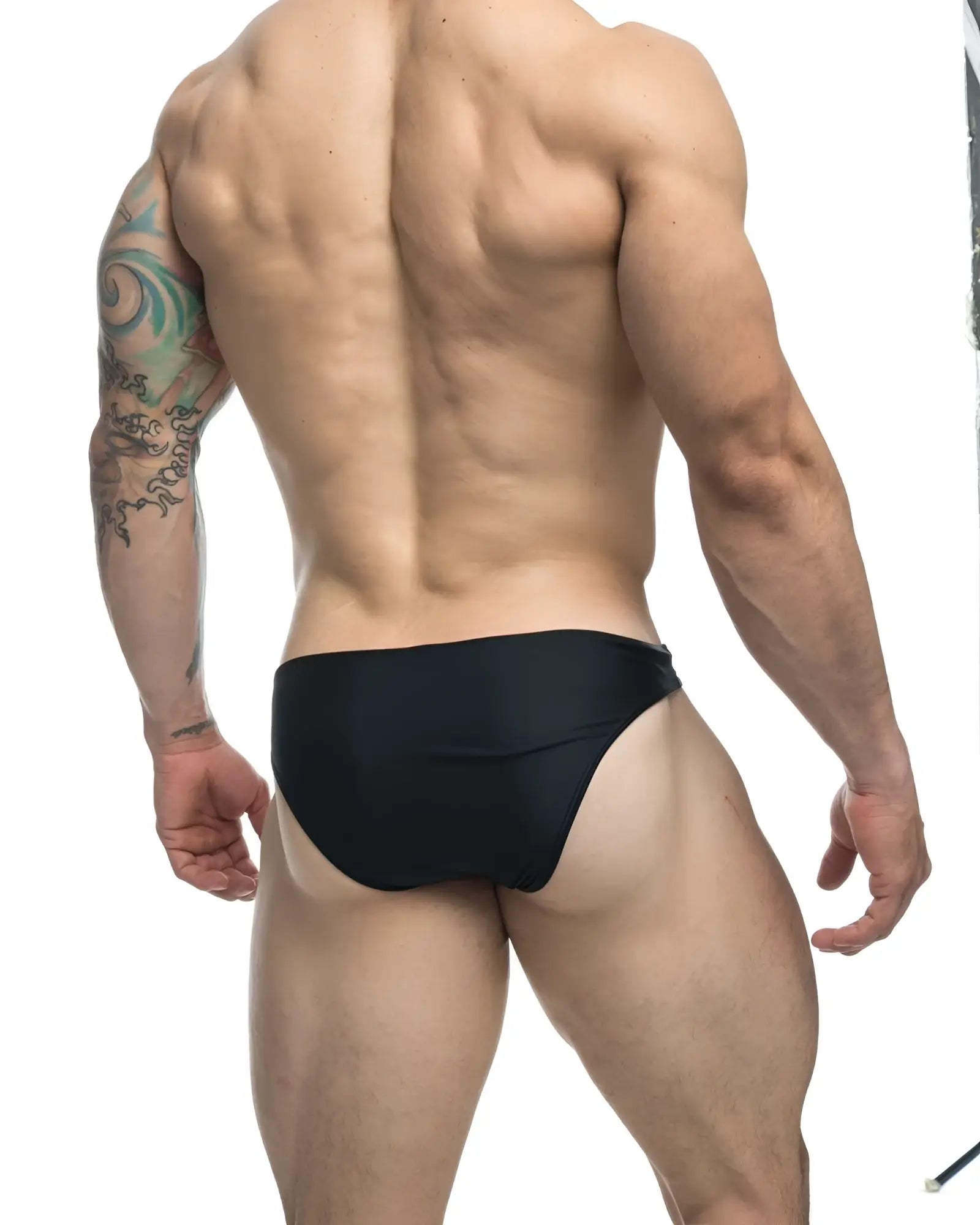 Black form-fitting swim trunks justin simon xsj01 classic bikini in color black for swimming and beachwear