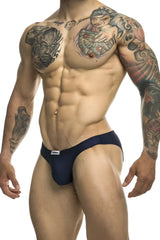 Navy blue justin simon classic bikini briefs with a small white brand tag on the waistband for athletic wear